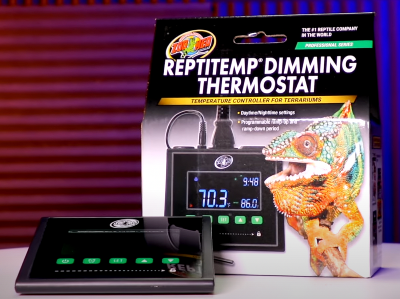 Reptile thermostat with packaging featuring a chameleon on a red and blue gradient background